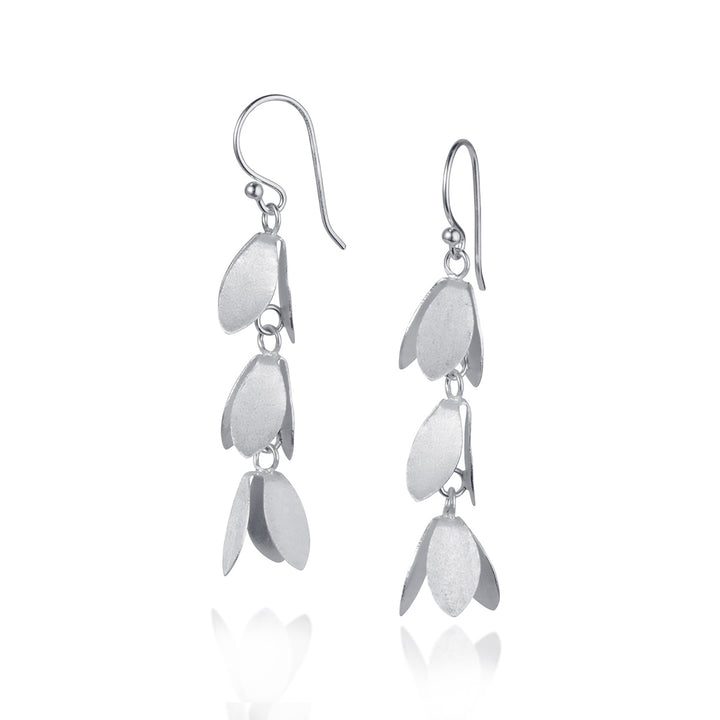 Silver dangle floral earrings on a white background