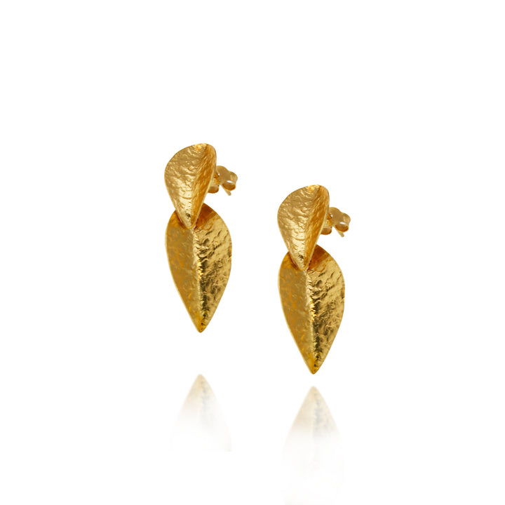 Pair of gold leaf-shaped earrings on a white background