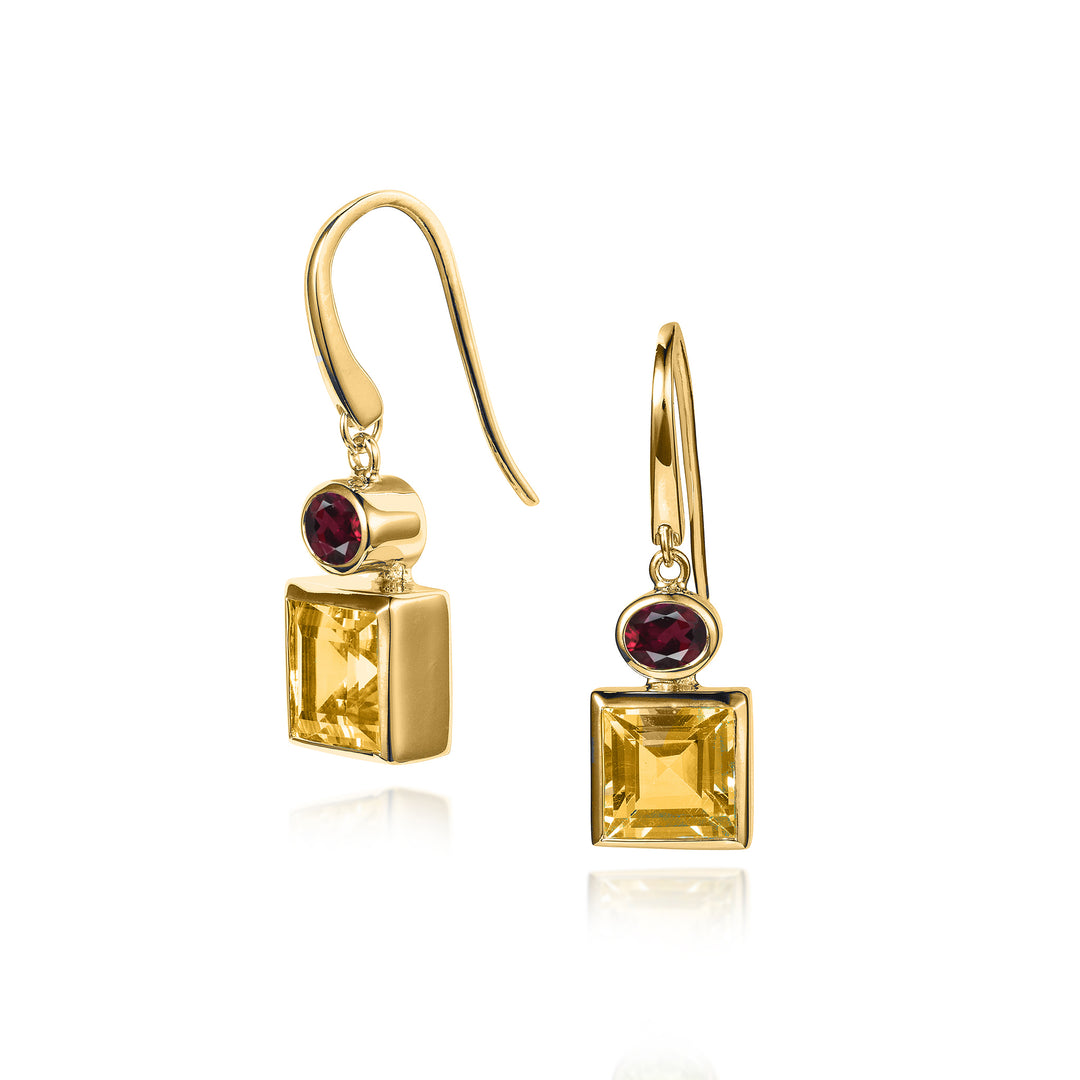 Gold hook earrings with square citrine and red garnet stones on a white background