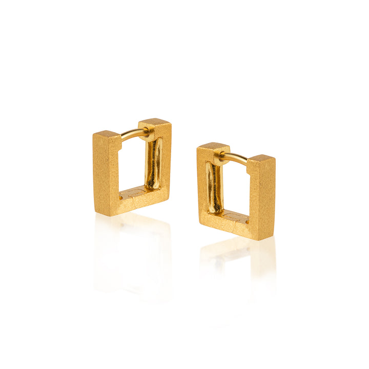 Square gold huggie hoop earrings on a white background