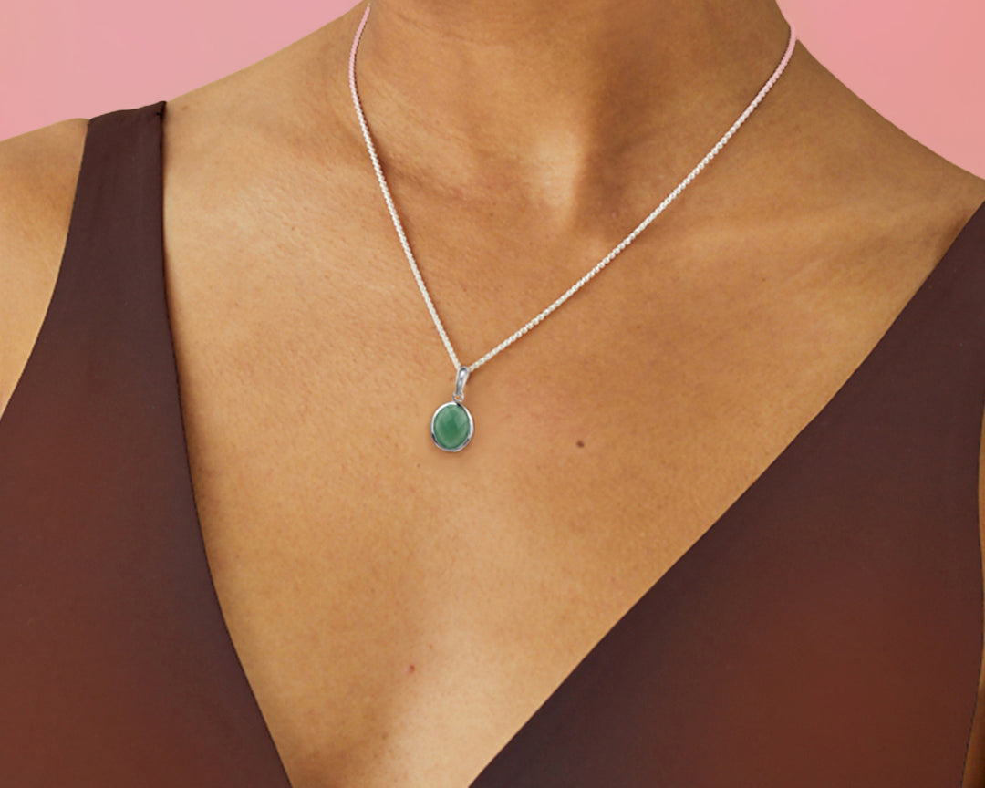 Close-up of woman wearing a green aventurine pendant necklace in sterling silver.