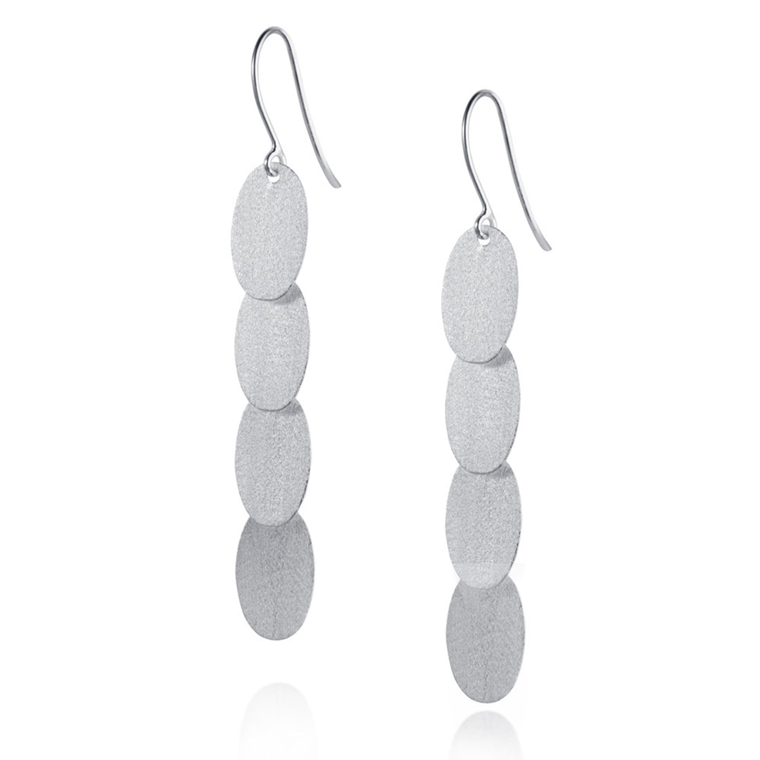 Pair of silver earrings with stacked oval pendants on a white background