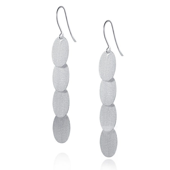 Pair of silver earrings with stacked oval pendants on a white background