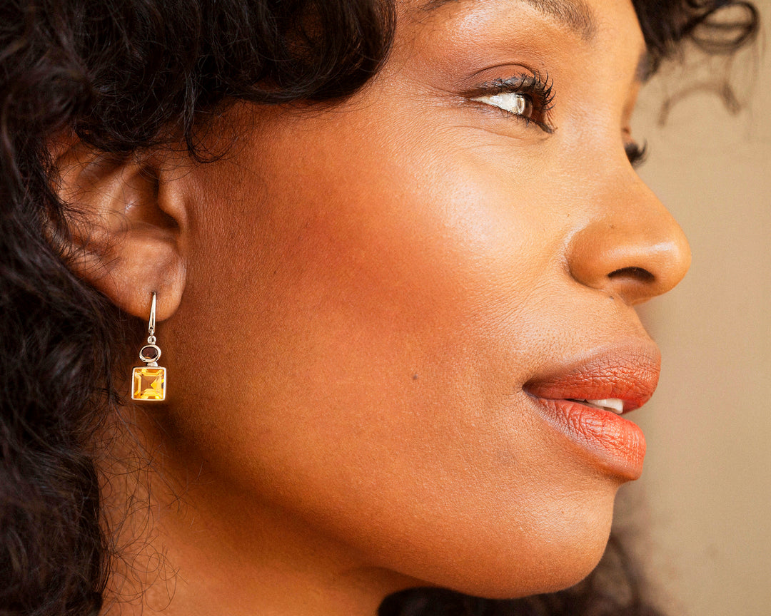 Side view of woman wearing citrine earrings in sterling silver
