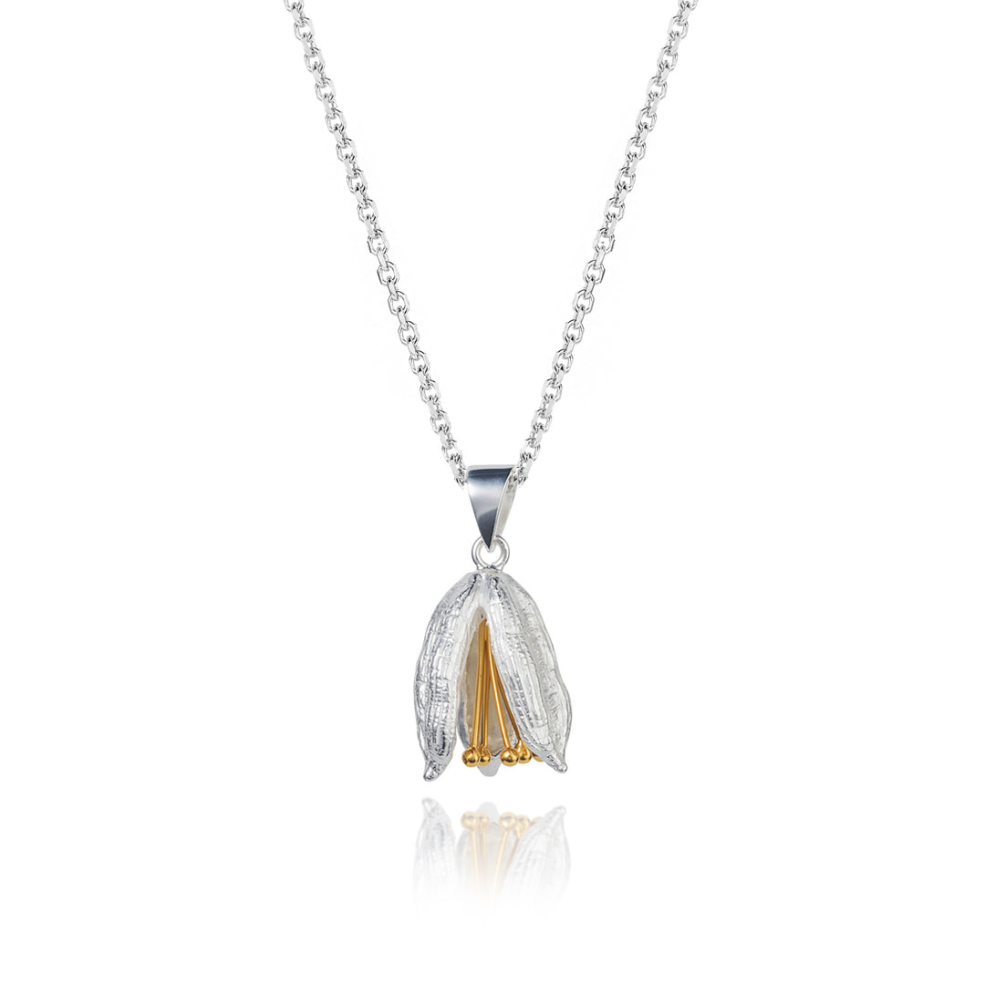 Silver and gold flower pod pendant necklace on a white background