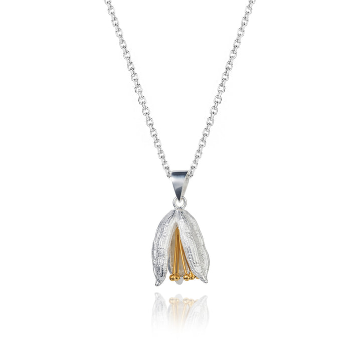 Silver and gold flower pod pendant necklace on a white background
