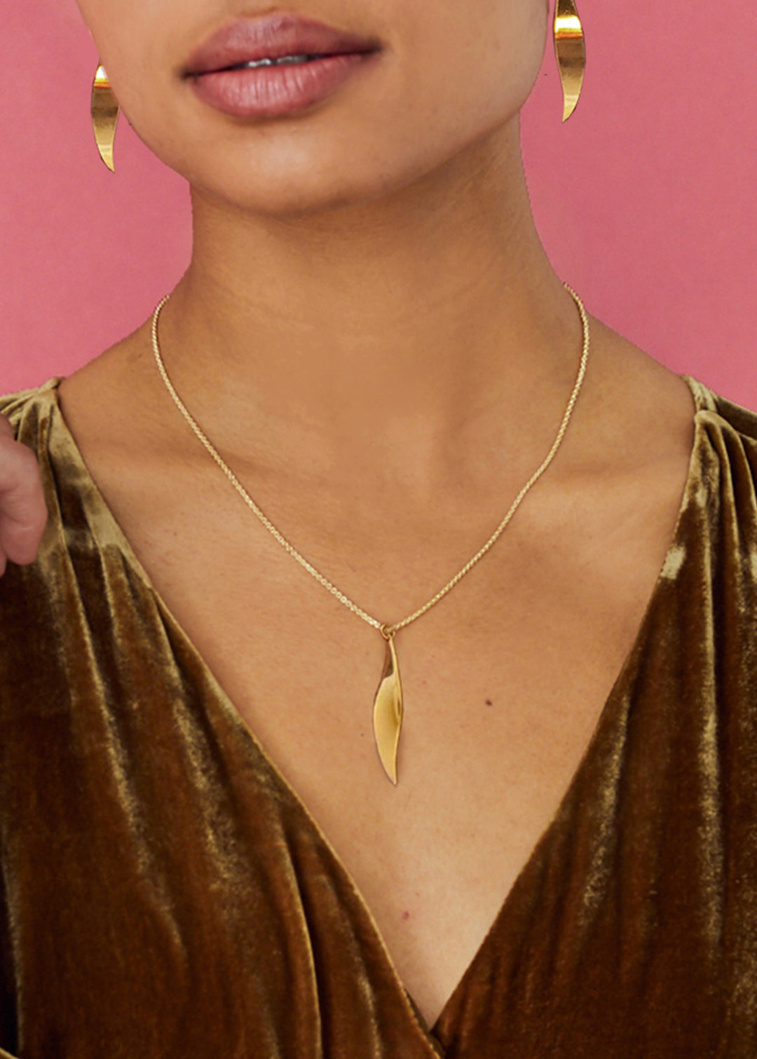 Model wearing gold pendant necklace and matching earrings from Christin Ranger Jewellery's Necklace Collection