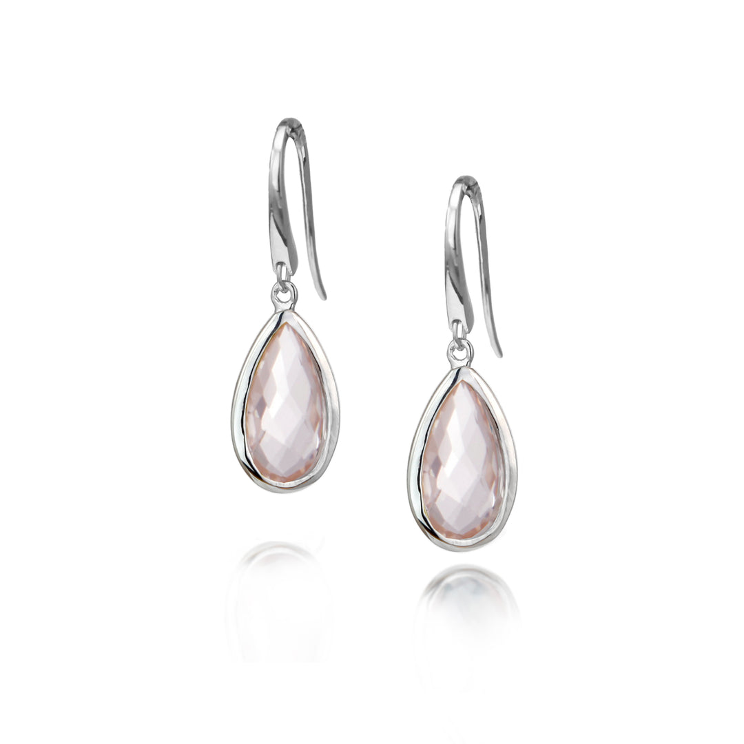 Silver teardrop earrings with pale pink gemstones on a white background