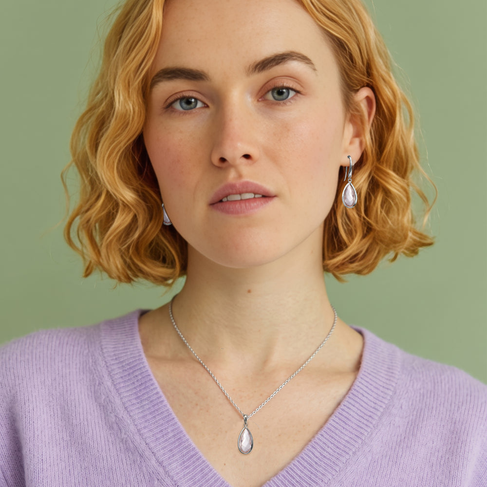 woman wearing rose quartz pear drop earring and necklace set with sterling silver