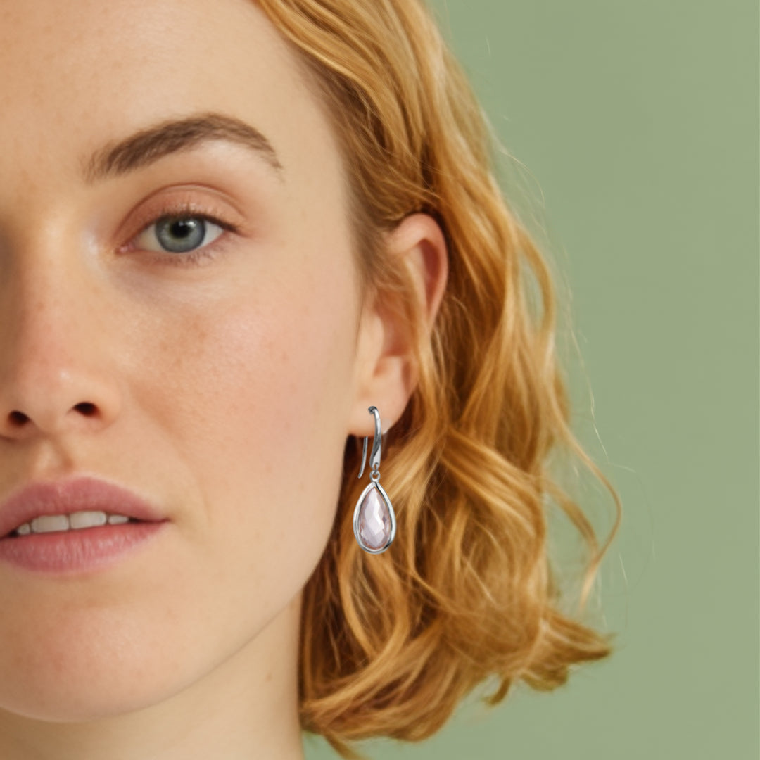 Close-up of woman wearing Rose quartz pear drop earring set with sterling silver