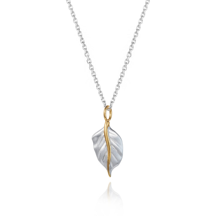 Silver leaf necklace with gold details on a white background