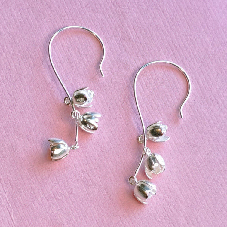 Alternative view of sterling silver lily of the valley long drop earrings on pink background