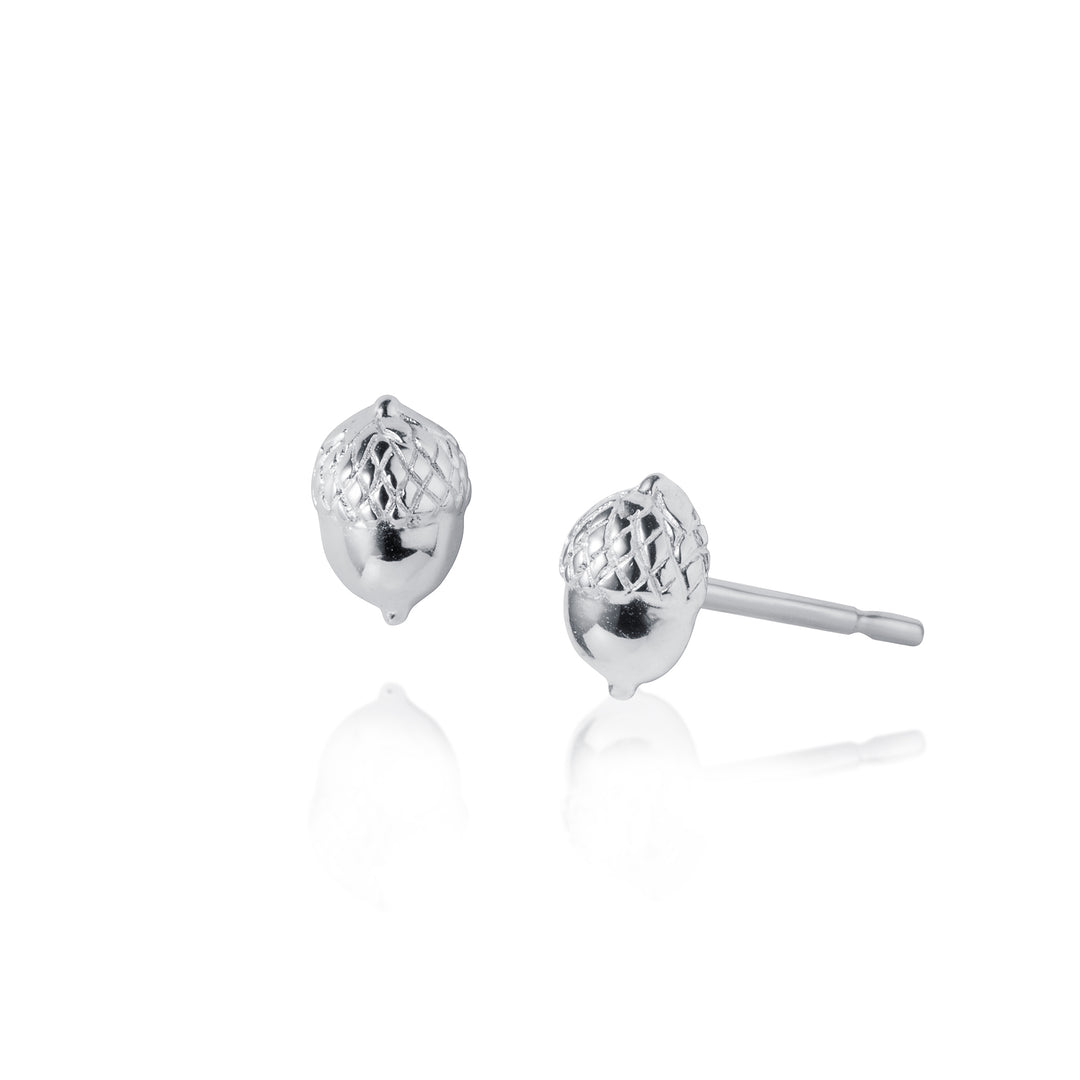 Pair of silver acorn-shaped stud earrings on a white background