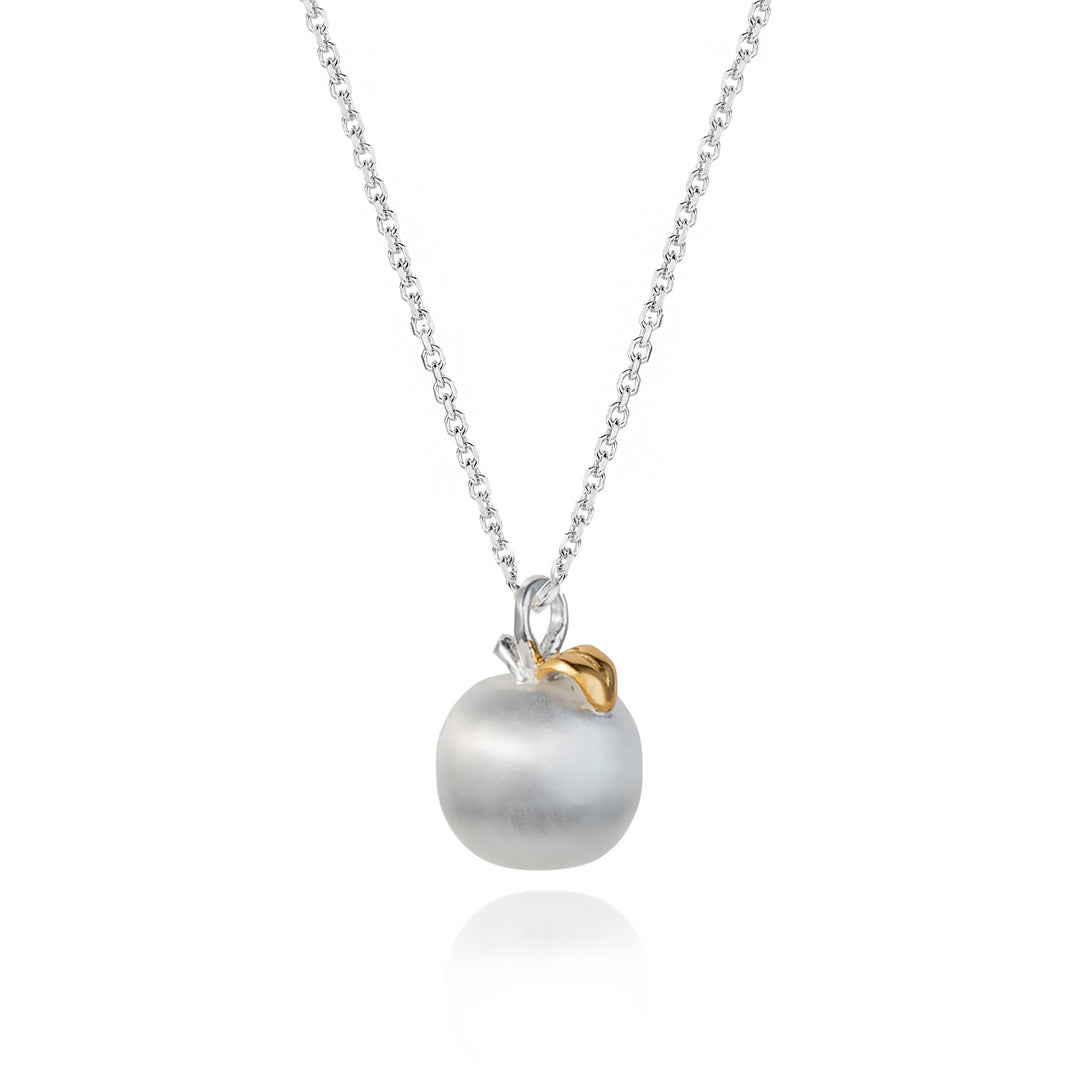 Silver apple necklace with a gold leaf on a white background