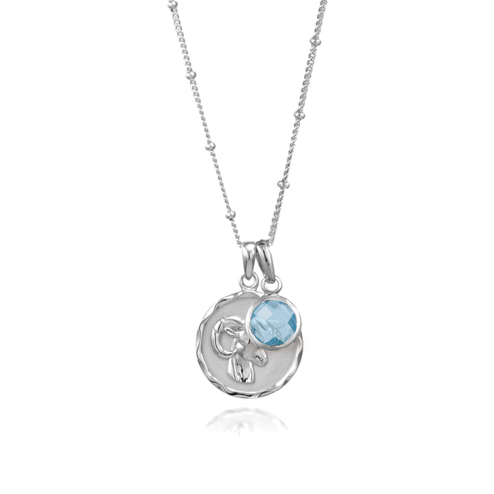 Silver Aries zodiac pendant and chain with blue topaz  march birthstone charm on white background