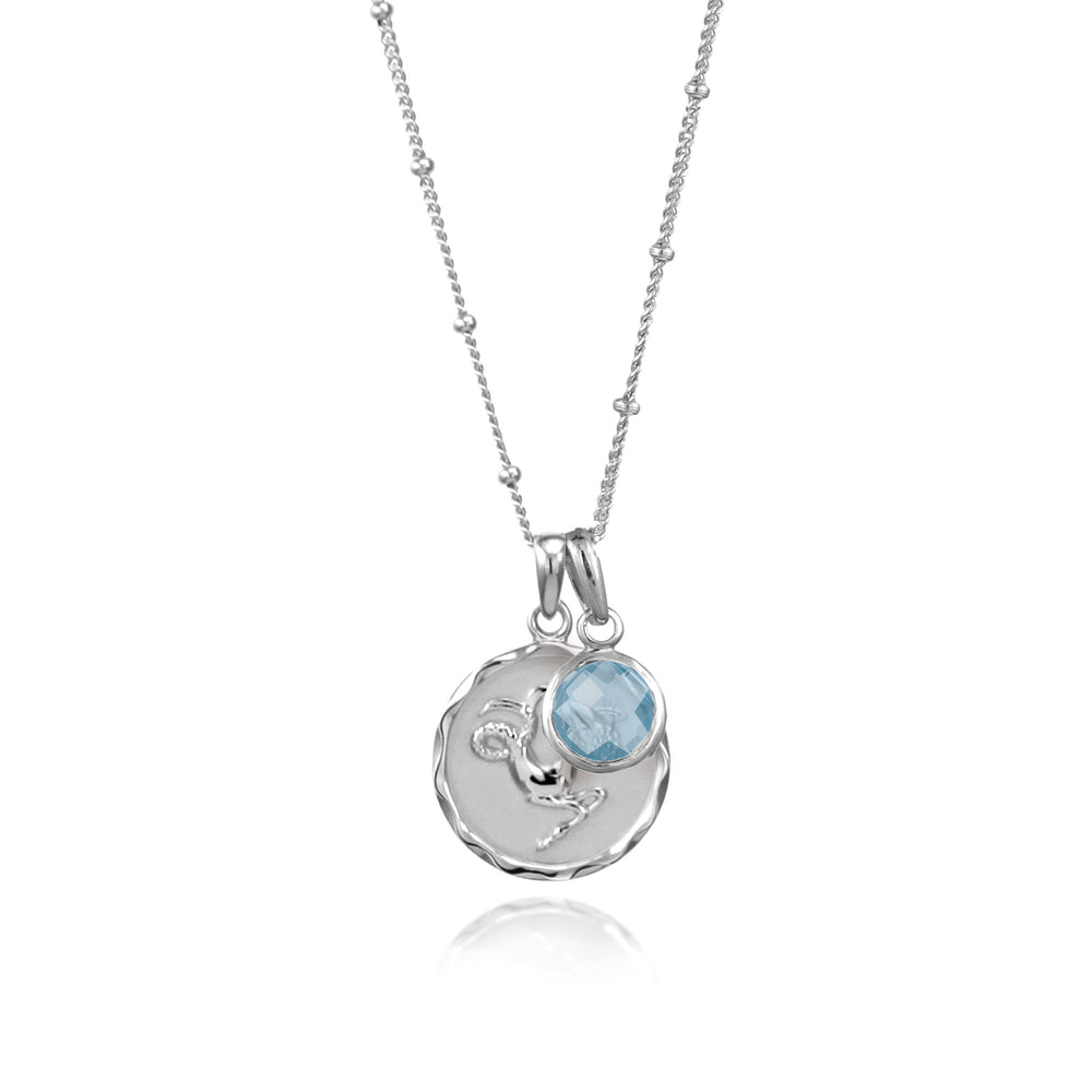Sterling silver Capricorn zodiac necklace with a blue topaz December birthstone charm