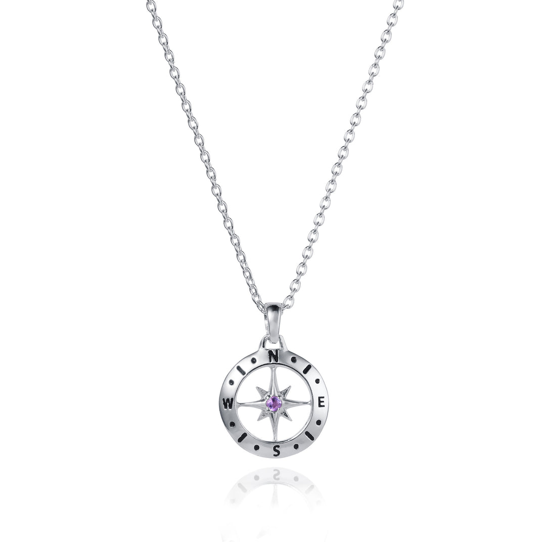 Dainty silver compass pendant with amethyst February birthstone on white background