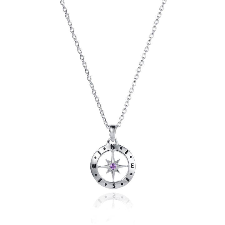 Dainty silver compass pendant with amethyst February birthstone on white background
