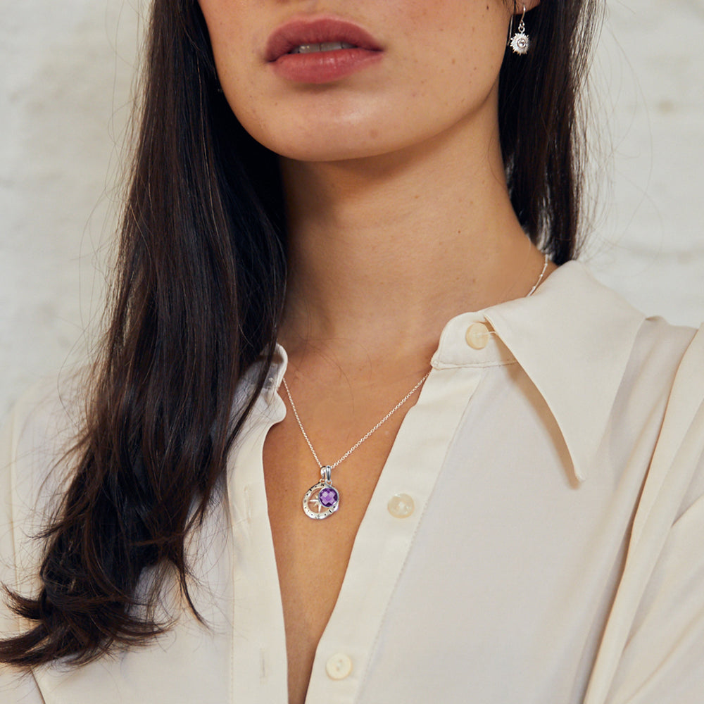 Model wearing silver compass necklace with birthstone charm