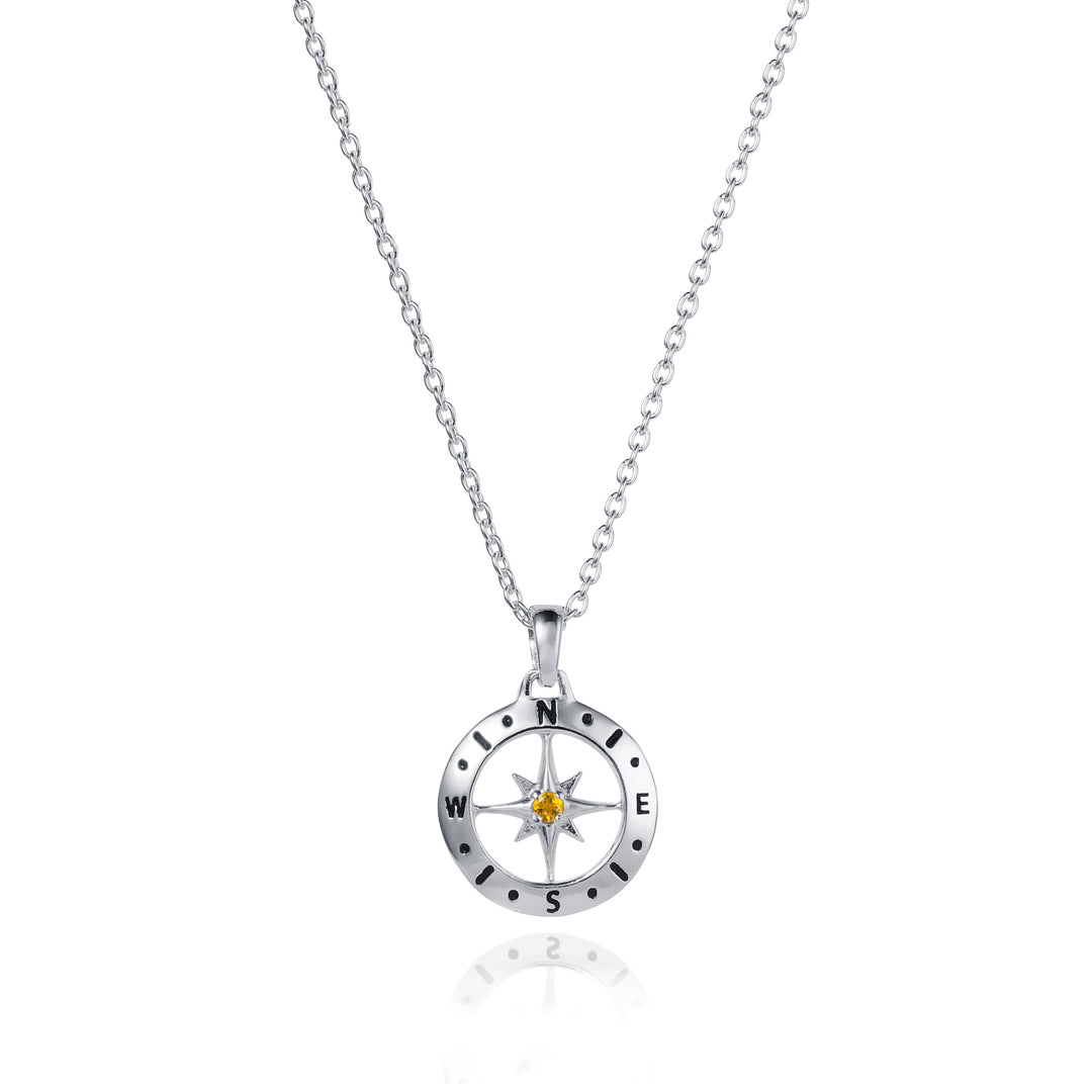 Dainty silver compass pendant with citrine December birthstone on white background