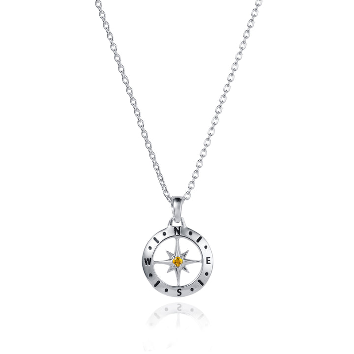Dainty silver compass pendant with citrine December birthstone on white background
