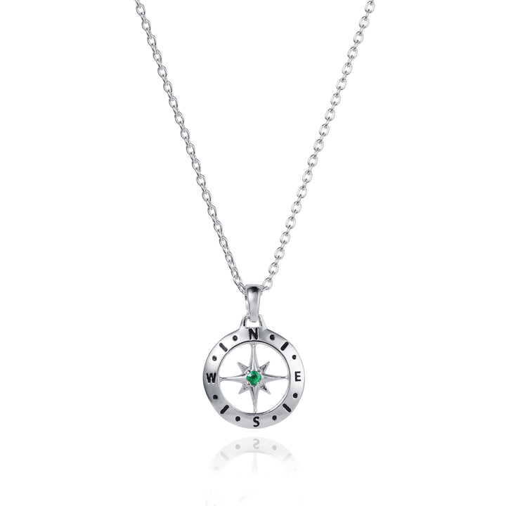 Dainty silver compass pendant with an emerald May birthstone on white background