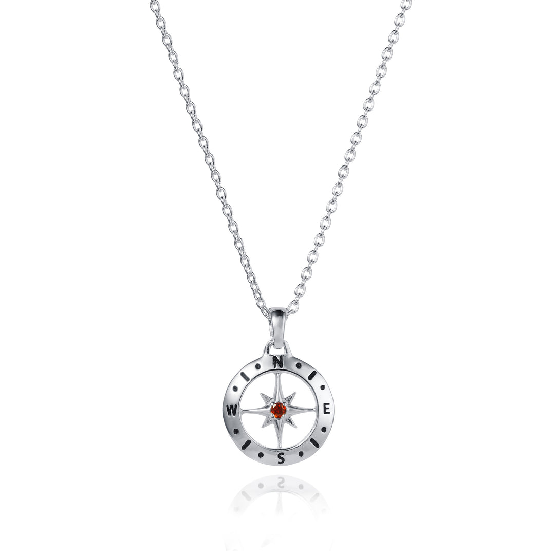 Dainty silver compass pendant with garnet january birthstone on white background