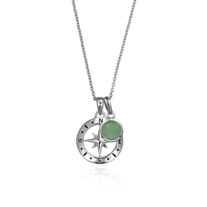 Silver compass necklace with a green quartz may birthstone charm pendant and chain on a white background