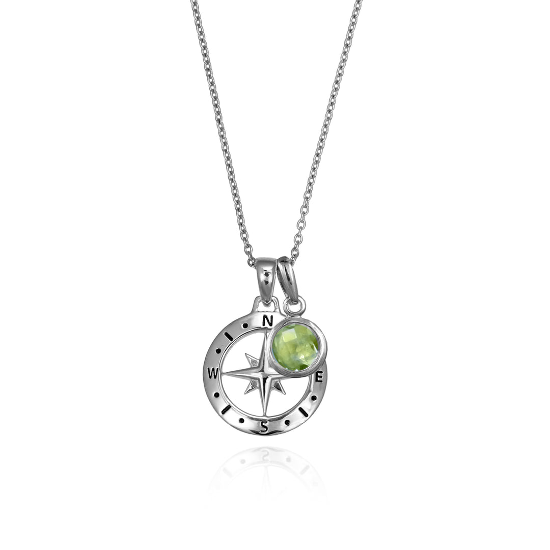 Silver compass necklace with a  green peridot august birthstone charm pendant and chain on a white background