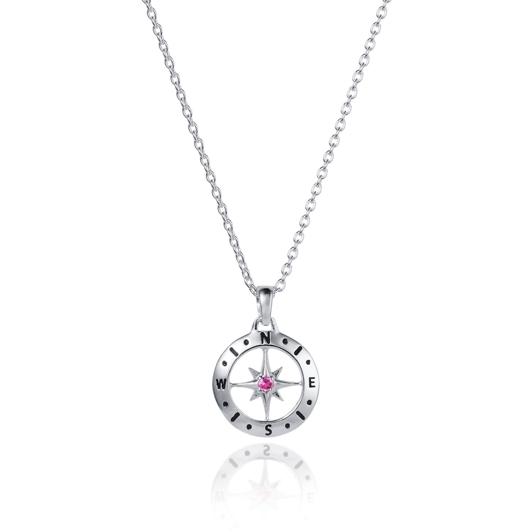Dainty silver compass pendant with pink tourmaline October birthstone on white background