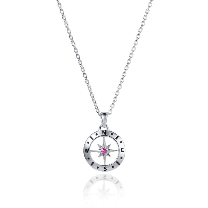 Dainty silver compass pendant with pink tourmaline October birthstone on white background