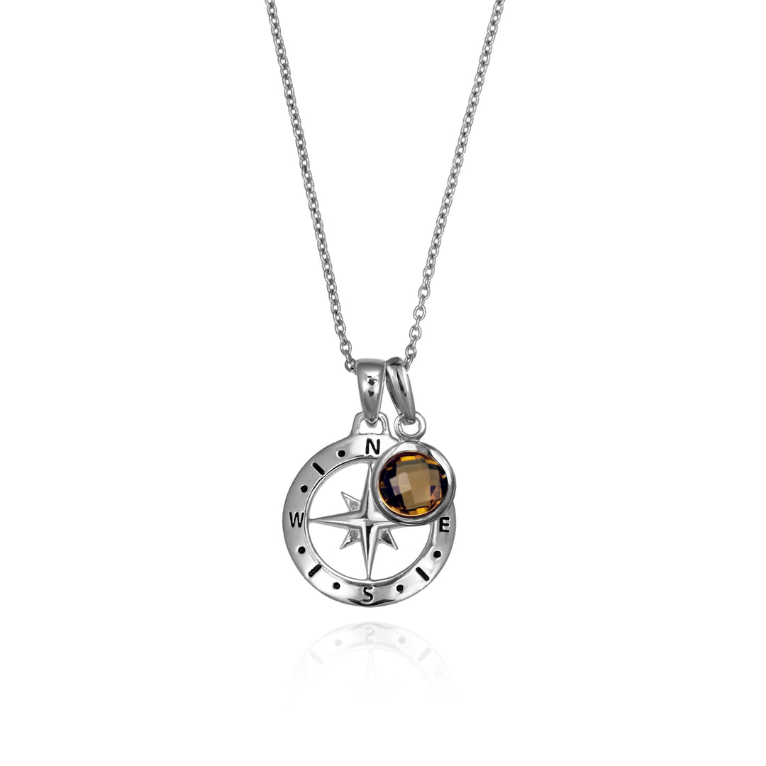 Silver compass necklace with a brown quartz november birthstone charm pendant and chain on a white background