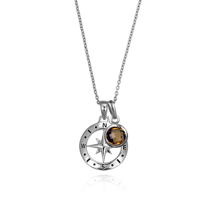 Silver compass necklace with a brown quartz november birthstone charm pendant and chain on a white background