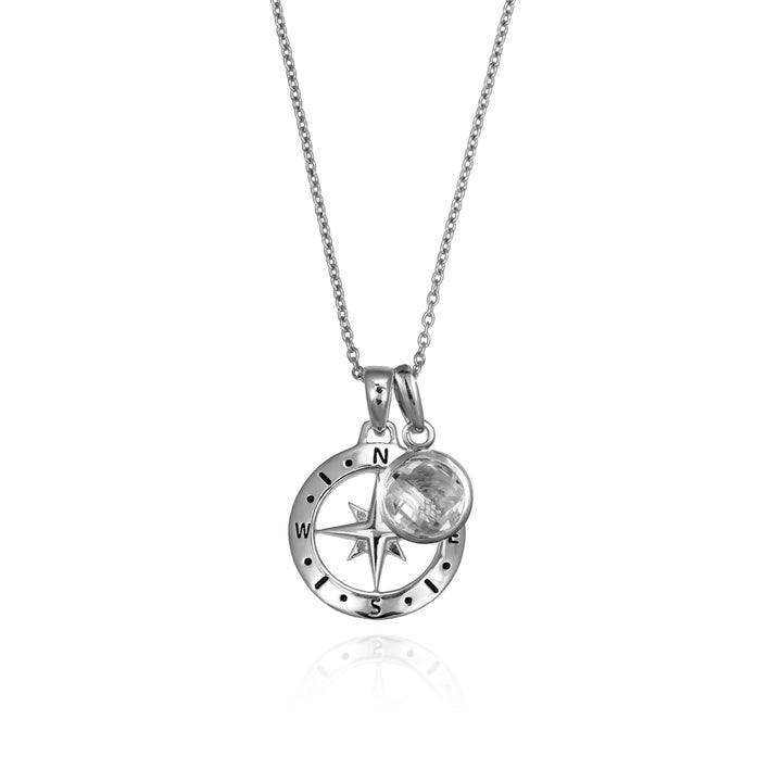 Silver compass necklace with a white topaz april birthstone charm pendant and chain on a white background