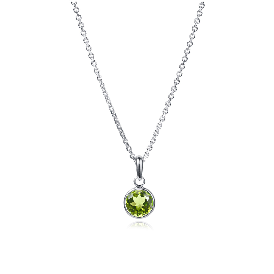 Silver necklace with a green gemstone pendant on a white background