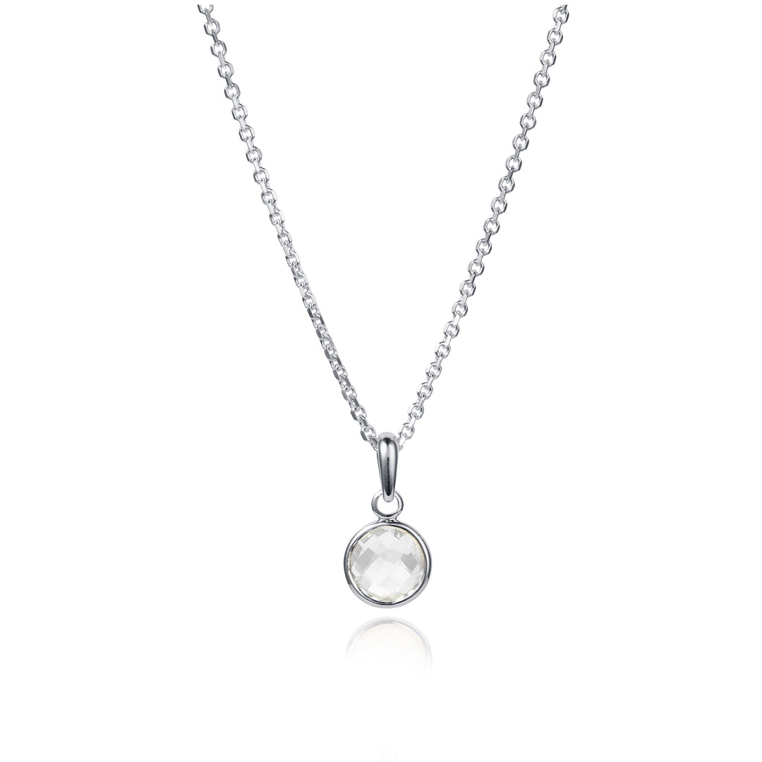 Dainty silver necklace with a small round white topaz gemstone on a white background