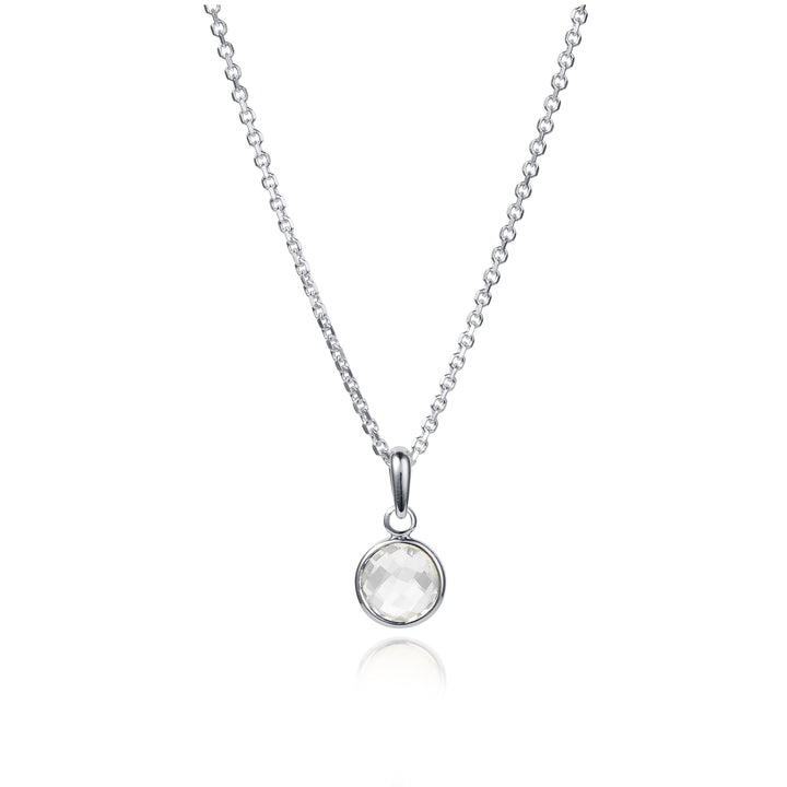 Dainty silver necklace with a small round white topaz gemstone on a white background