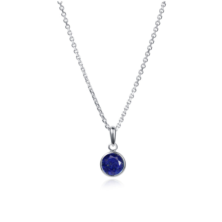 Silver necklace with a dainty blue lapis gemstone pendant on a white background