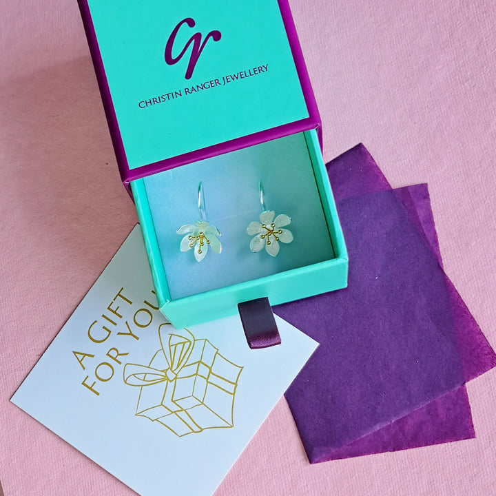Sterling silver daisy flower drop earrings in Christin Ranger gift packaging