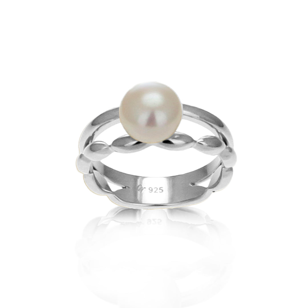 Front view of a large pearl ring in silver on a white background