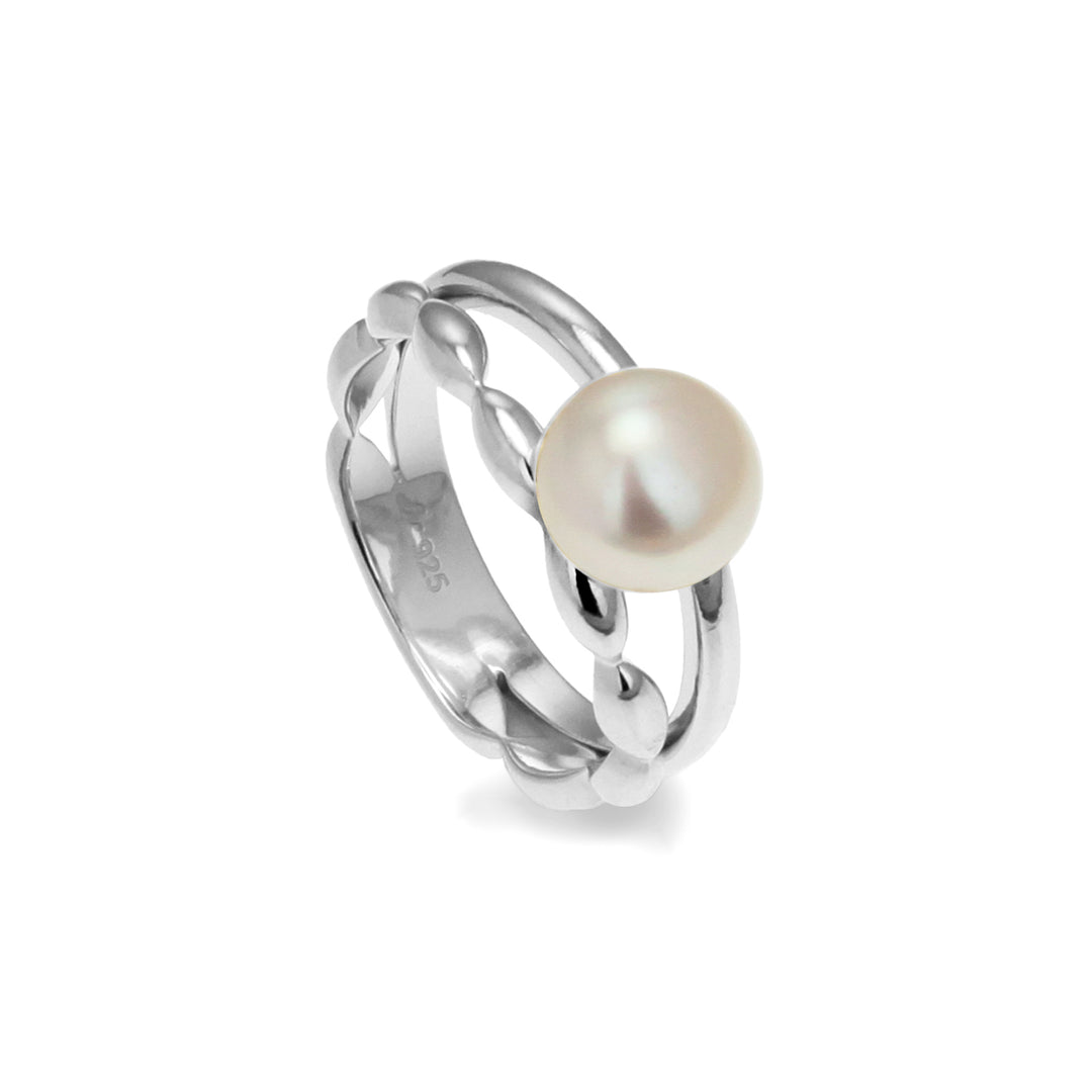 Freshwater pearl ring with two different silver bands on a white background
