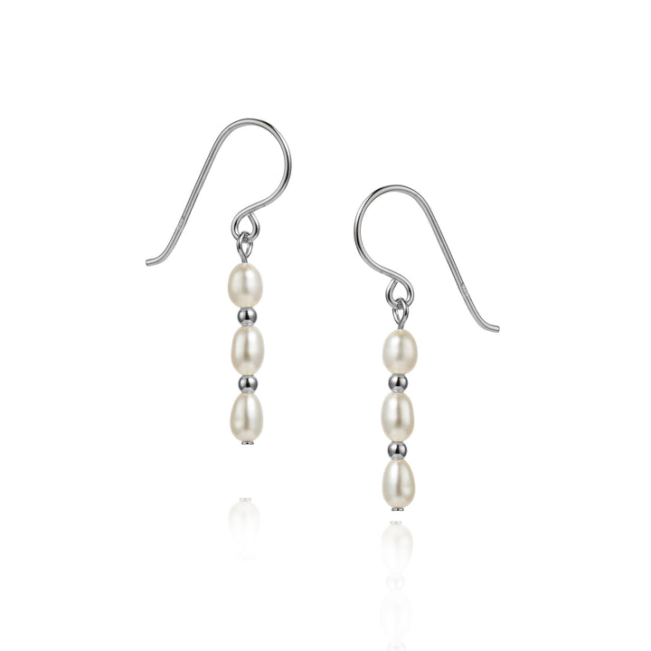 Pair of silver three pearl earrings on a white background