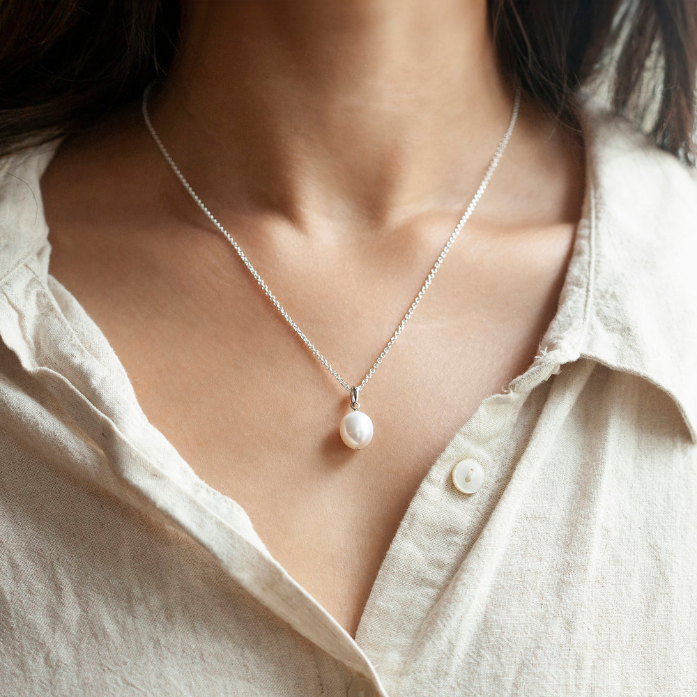Model wearing a sterling silver freshwater pearl drop pendant necklace