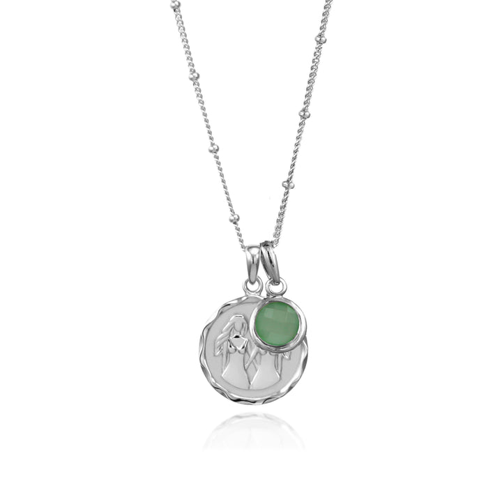 Silver gemini zodiac pendant and green quartz May birthstone charm on a white background