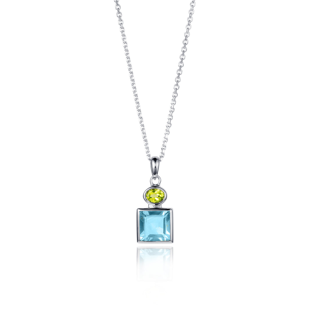Silver necklace featuring a square blue topaz and oval peridot gemstone on a white background