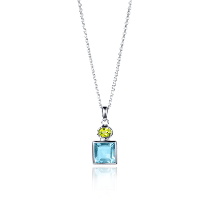Silver necklace featuring a square blue topaz and oval peridot gemstone on a white background