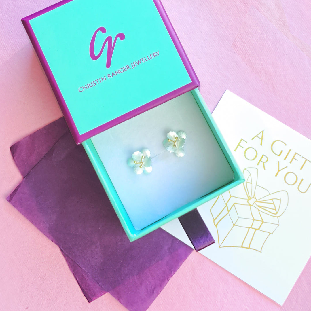 Sterling silver and gold vermeil cherry blossom stud earrings in Christin Ranger gift packaging