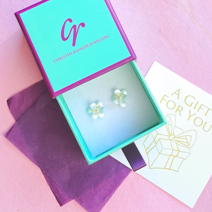 Sterling silver and gold vermeil cherry blossom stud earrings in Christin Ranger gift packaging