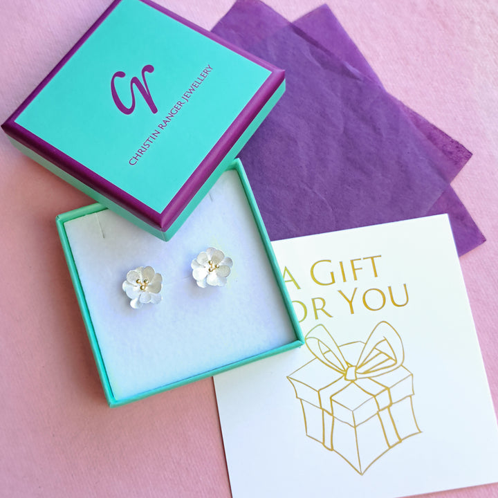 Sterling silver and gold vermeil double daisy stud earrings in Christin Ranger gift packaging"
