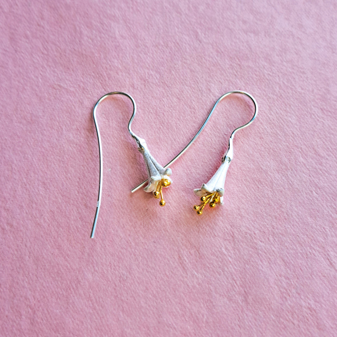 Sterling silver and gold fuchsia drop earrings on a pink background showing threader hook detail